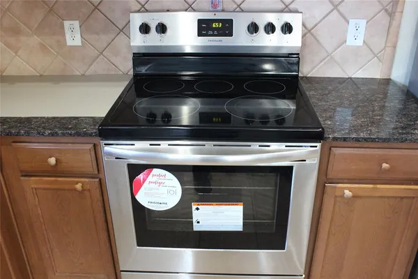 a stove top oven sitting inside of a kitchen