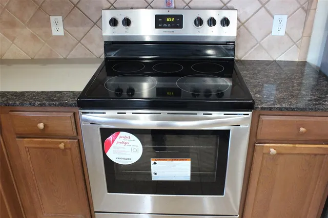 a stove top oven sitting inside of a kitchen