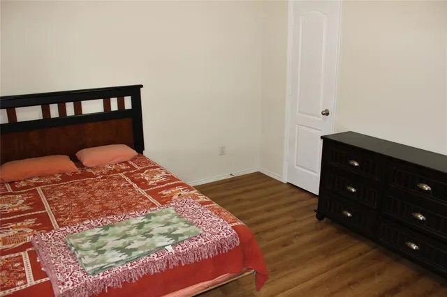 a bedroom with a bed and a dresser