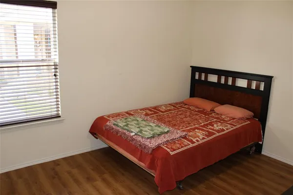 a bed sitting in a bedroom next to a window