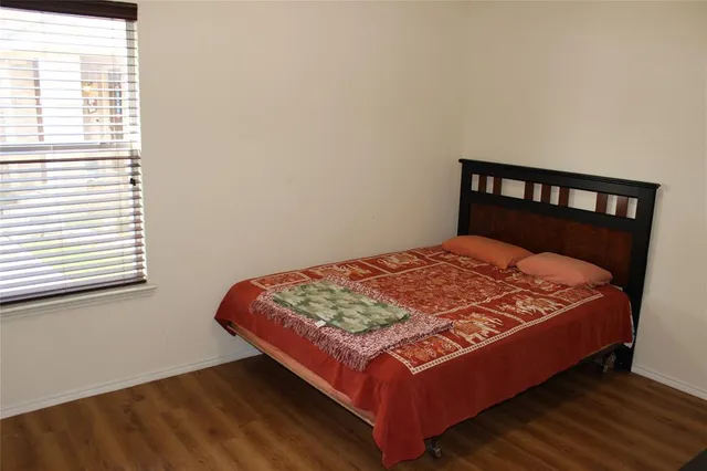 a bed sitting in a bedroom next to a window