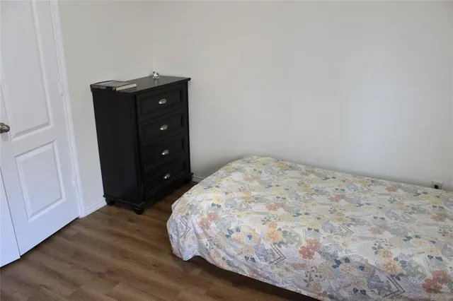a bedroom with a bed and a dresser