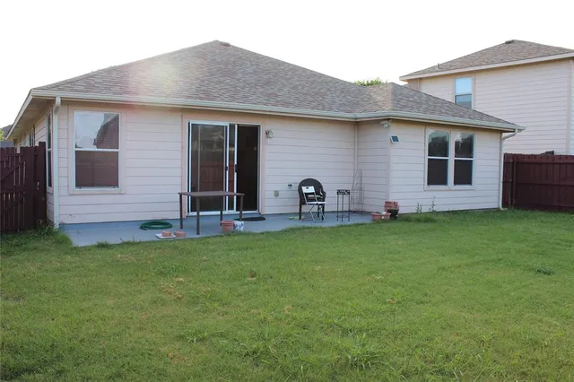 a front view of house with yard and outdoor seating