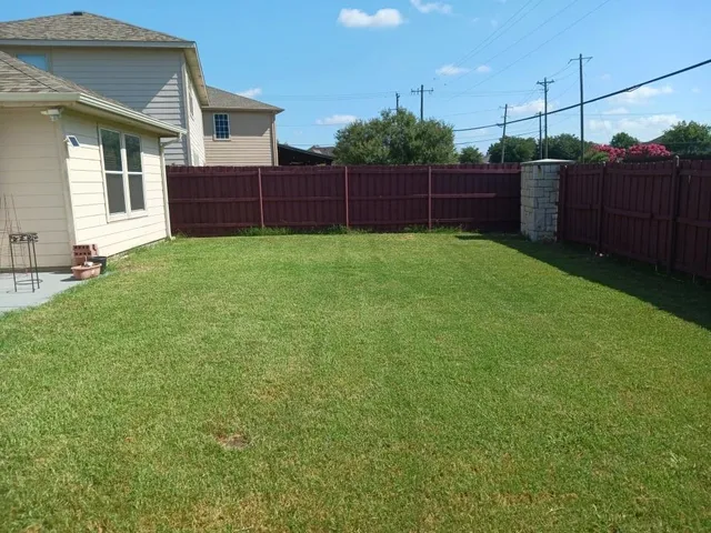 a yard with wooden fence
