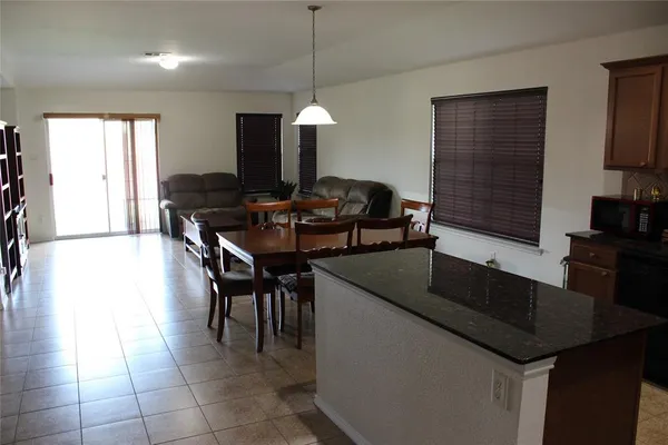 a kitchen with a sink a counter space and chairs