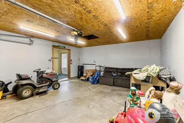 a view of a backyard with a large tree and wooden fence