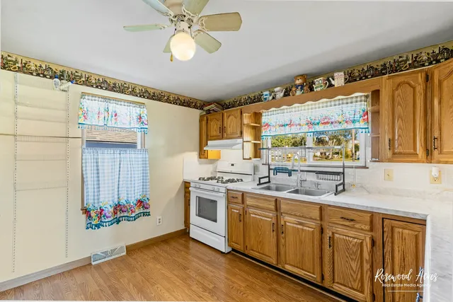 a kitchen with a stove a sink and a refrigerator