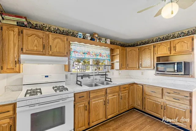 a kitchen with cabinets wooden floor and a sink