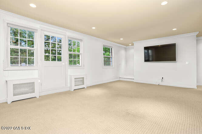 80 Putnam Park Greenwich, CT 06830 - Photo 3 of 20 a view of an empty room with a window and a kitchen