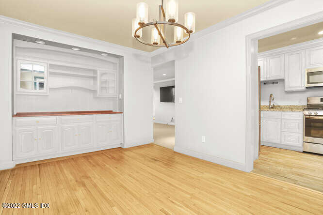 80 Putnam Park Greenwich, CT 06830 - Photo 5 of 20 a view of empty room with wooden floor and kitchen view