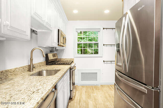 80 Putnam Park Greenwich, CT 06830 - Photo 7 of 20 a kitchen with stainless steel appliances granite countertop a sink stove and refrigerator
