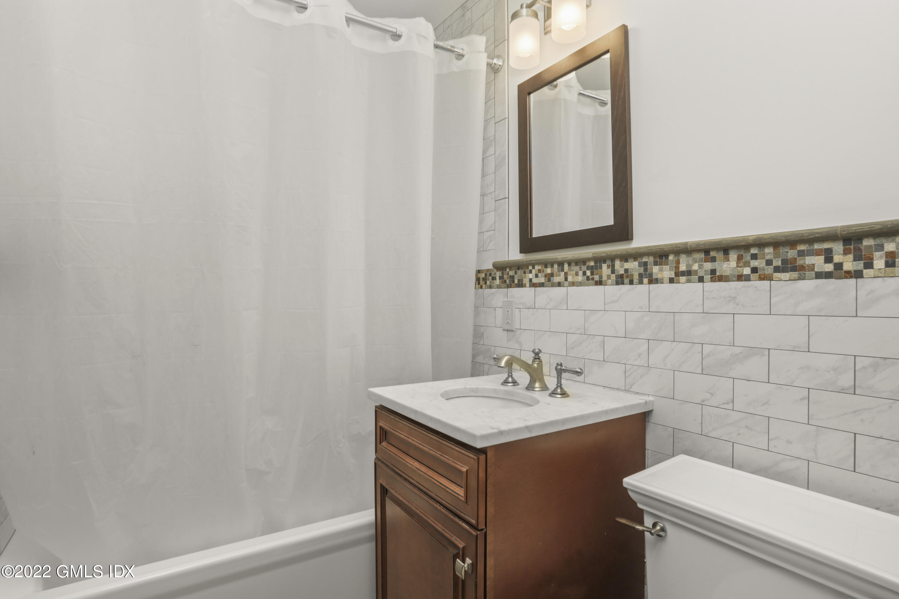 80 Putnam Park Greenwich, CT 06830 - Photo 9 of 20 a bathroom with a sink a toilet and a mirror