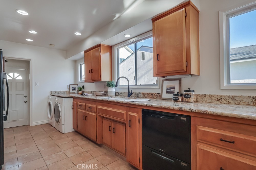 3562 North Studebaker Road Long Beach, CA 90808 - Photo 11 of 39 a kitchen with a sink stove and cabinets