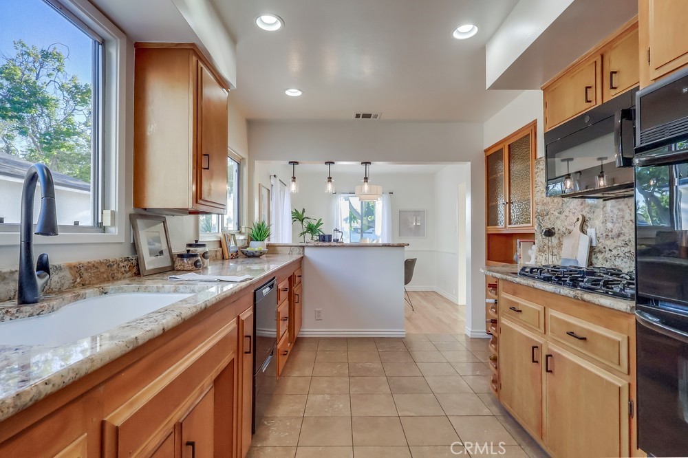 3562 North Studebaker Road Long Beach, CA 90808 - Photo 12 of 39 a kitchen with stainless steel appliances granite countertop a sink stove and cabinets