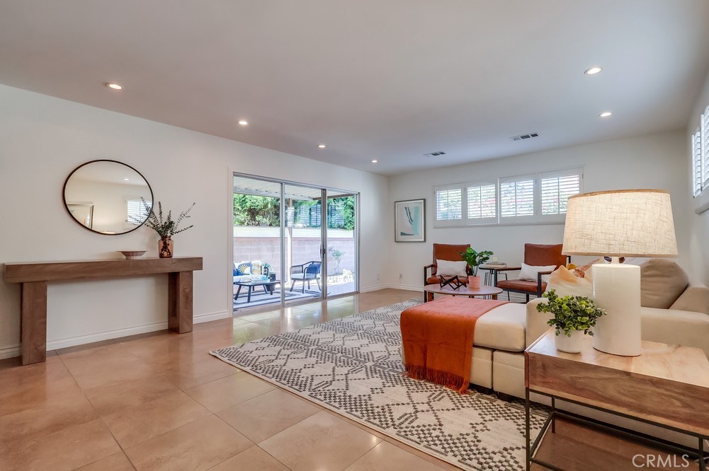 3562 North Studebaker Road Long Beach, CA 90808 - Photo 18 of 39 a living room with furniture a large window and a chandelier