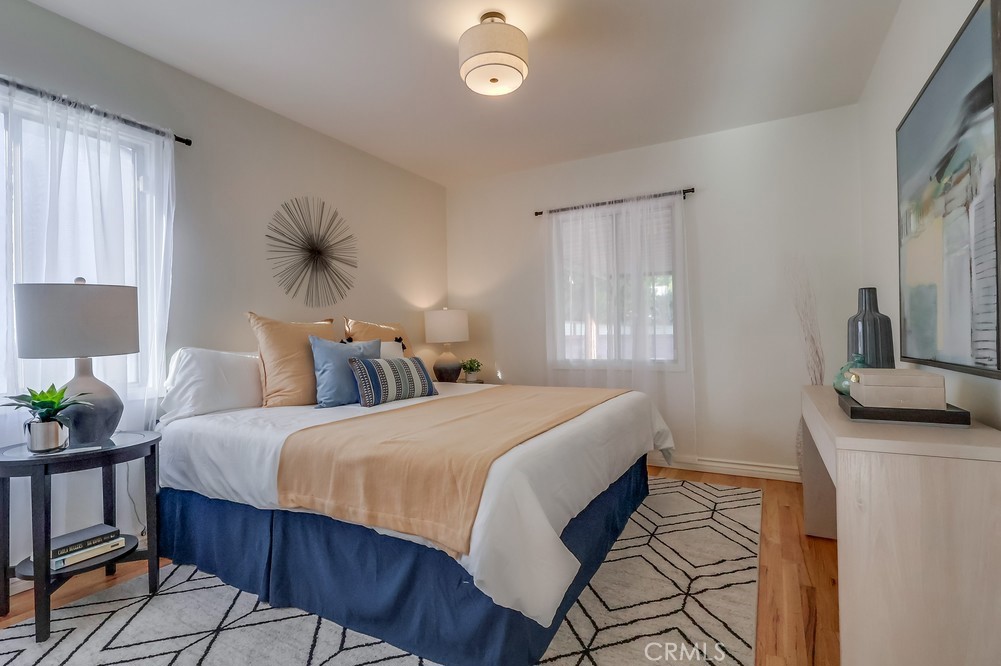 3562 North Studebaker Road Long Beach, CA 90808 - Photo 30 of 39 a bedroom with a bed and a potted plant