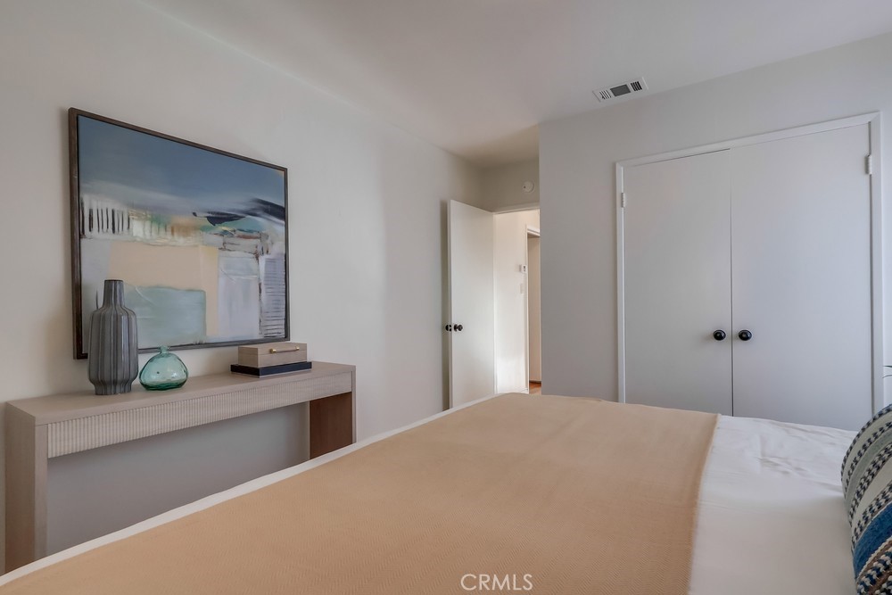3562 North Studebaker Road Long Beach, CA 90808 - Photo 32 of 39 a bedroom with a granite countertop sink and a mirror