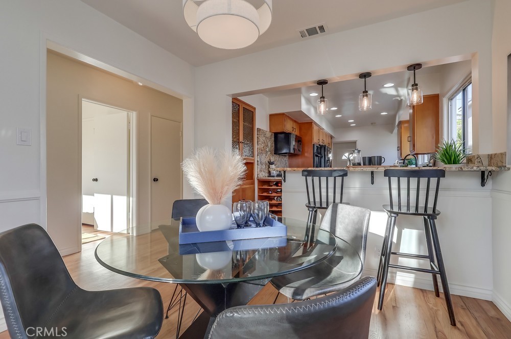 3562 North Studebaker Road Long Beach, CA 90808 - Photo 5 of 39 a dining room with furniture a rug and wooden floor