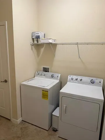 a view of a patio with a table and chairs