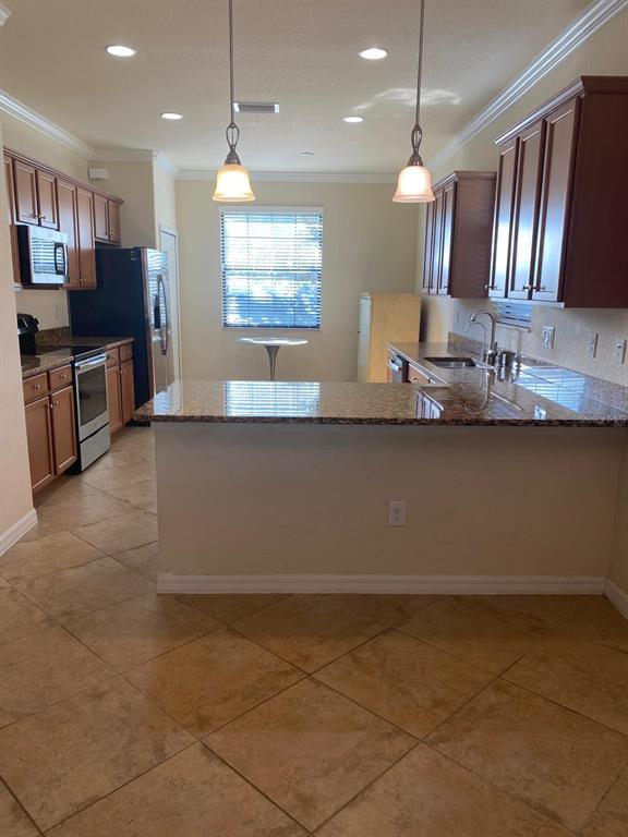 12792 Richezza Drive Venice, FL 34293 - Photo 5 of 24 a view of a kitchen with electric appliances