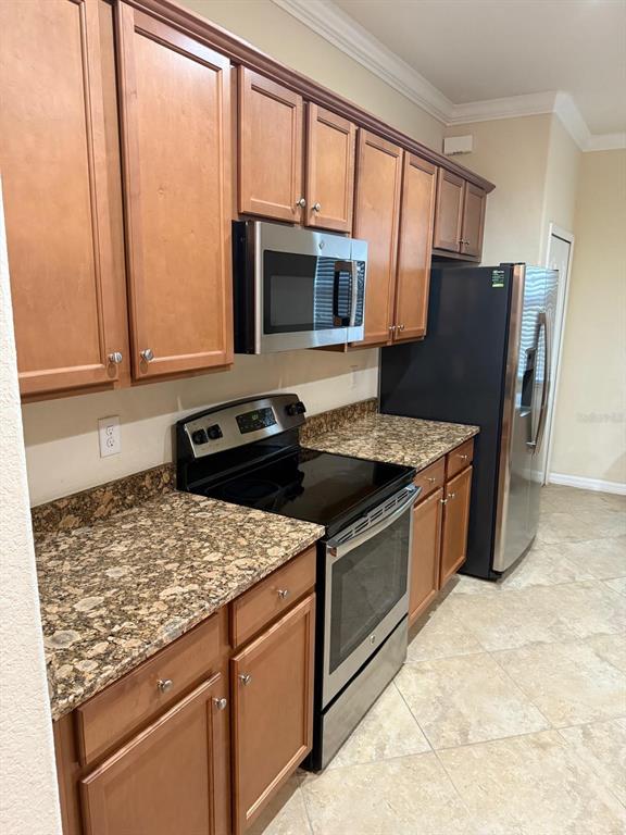 12792 Richezza Drive Venice, FL 34293 - Photo 6 of 24 a kitchen with stainless steel appliances granite countertop a stove a sink and a microwave