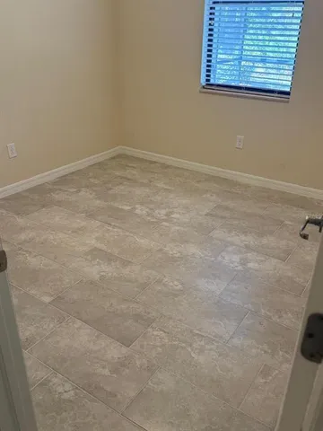 a view of a room with an empty space and a window