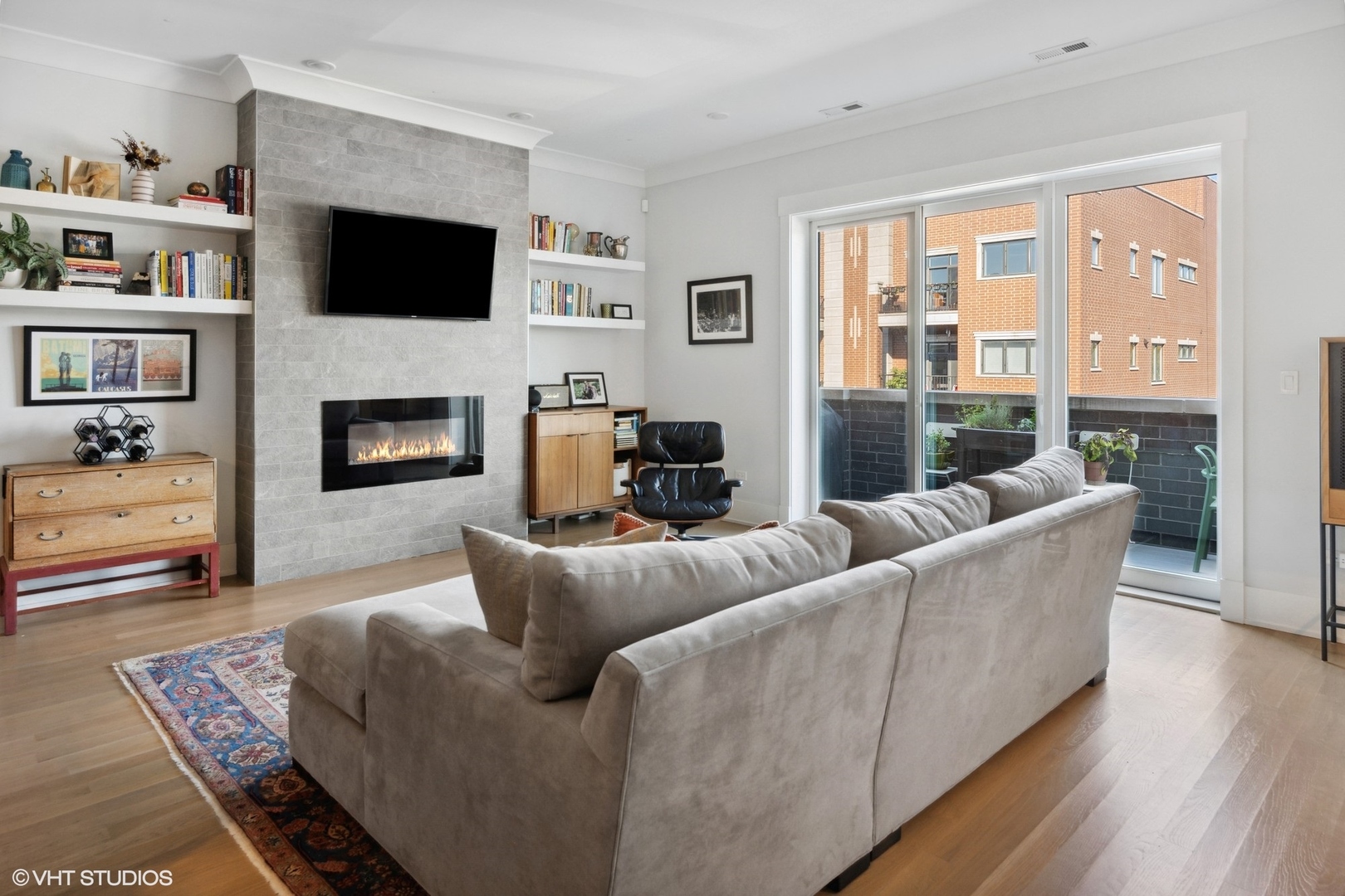 2751 West Lawrence Avenue, Unit 3W Chicago, IL 60625 - Photo 4 of 21 a living room with furniture a flat screen tv and a fireplace