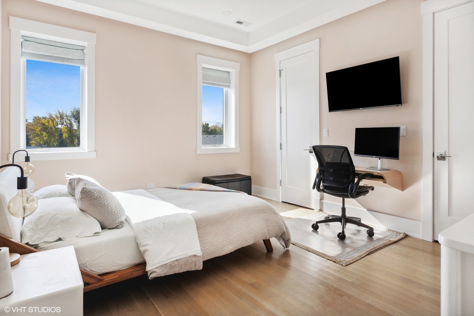 2751 West Lawrence Avenue, Unit 3W Chicago, IL 60625 - Photo 10 of 21 a bedroom with a bed a flat screen tv and a couch