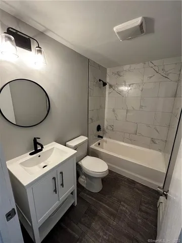 a bathroom with a double vanity sink toilet mirror and shower