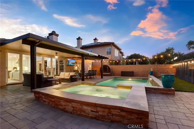 a view of a house with swimming pool and sitting area