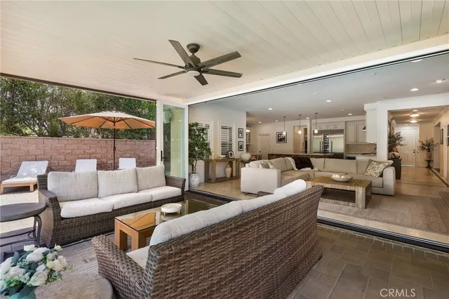 a living room with furniture a fireplace and a large window