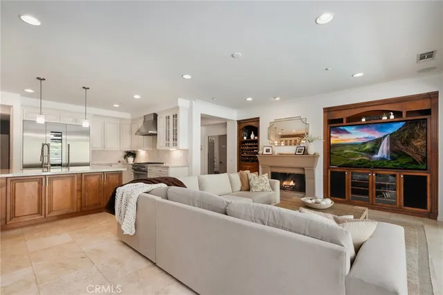 a large kitchen with kitchen island a large center island a sink stainless steel appliances and cabinets