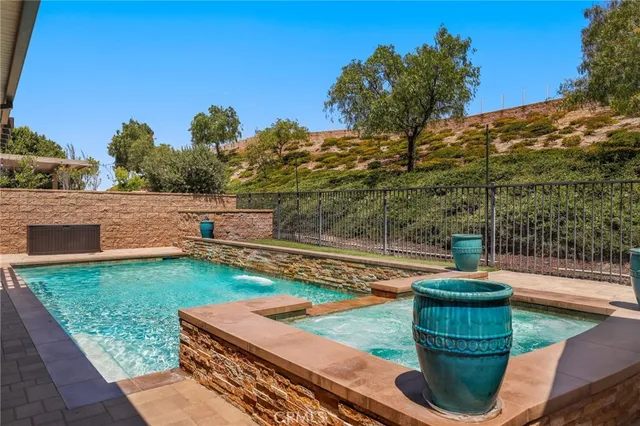 a view of a house with swimming pool and sitting area
