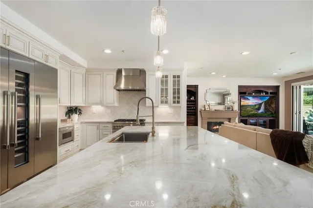 a bathroom with a granite countertop double vanity sink and a mirror