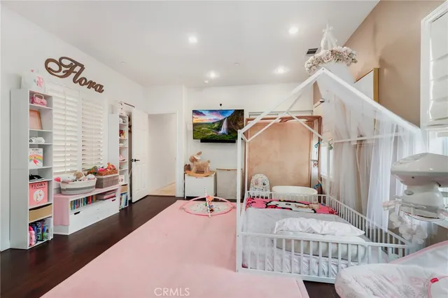 an aerial view of residential houses with outdoor space and trees