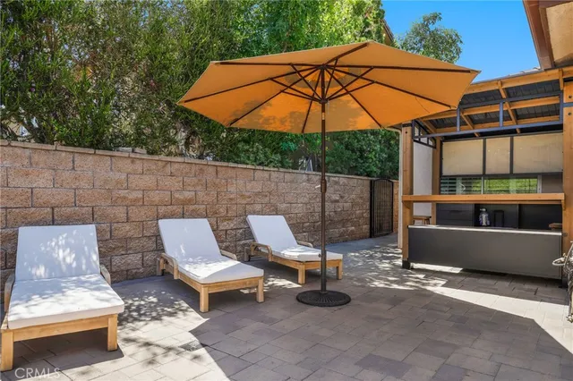 an aerial view of residential house with outdoor space and trees all around