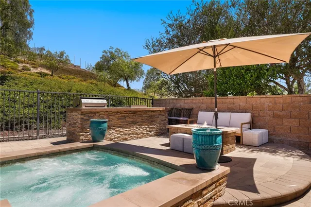 a view of a swimming pool with lawn chairs and a big yard