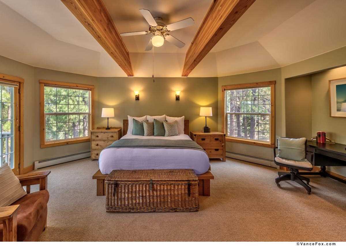 378 Skidder Trail Truckee, CA 96161 - Photo 11 of 21 a bedroom with a bed a desk chair and windows