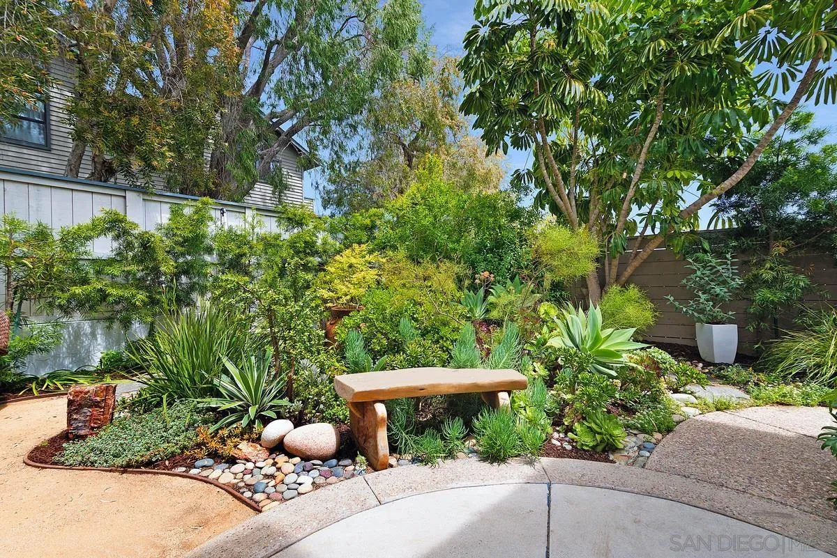 172 Avocado Street Encinitas, CA 92024 - Photo 13 of 19 a view of a garden with a bench