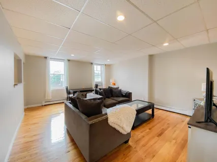 a living room with furniture and a flat screen tv