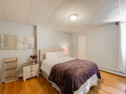 a bed room with a bed and a night stand