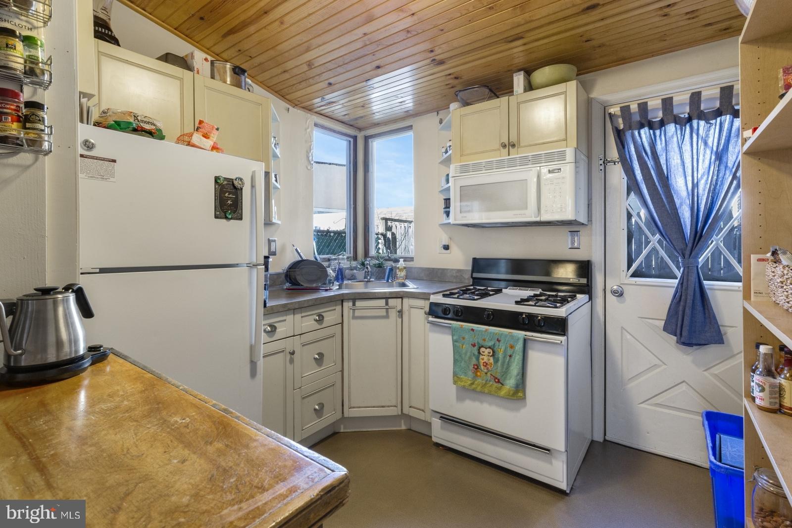 2228 Taggert Street Philadelphia, PA 19125 - Photo 7 of 23 a kitchen with stainless steel appliances granite countertop a sink stove and refrigerator