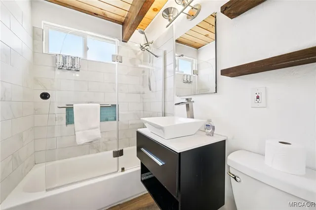 a bathroom with a sink toilet tub and shower