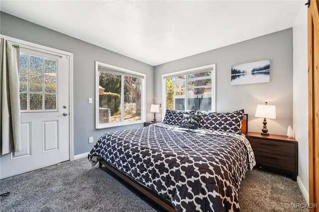 a bedroom with a large bed and a window