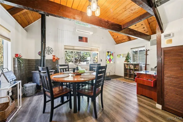 a dining room with furniture and wooden floor