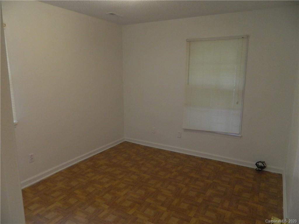 5718 Trotters Ridge Road Charlotte, NC 28227 - Photo 13 of 18 an empty room with a bench