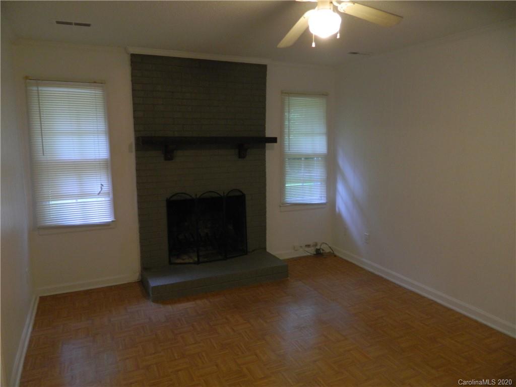 5718 Trotters Ridge Road Charlotte, NC 28227 - Photo 9 of 18 an empty room with a fireplace