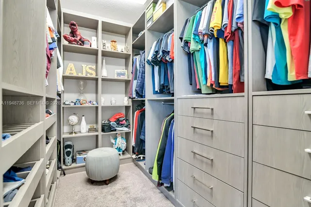 a en suite bathroom with a granite countertop sink and a mirror