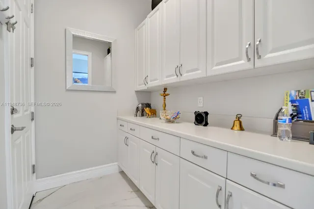 a kitchen with white cabinets and a sink
