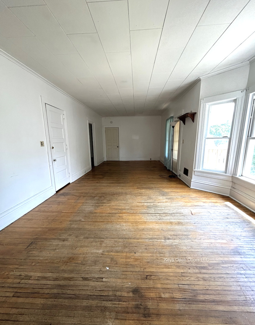 509 Fifth Street Aurora, IL 60505 - Photo 11 of 14 a view of an empty room with window and wooden floor